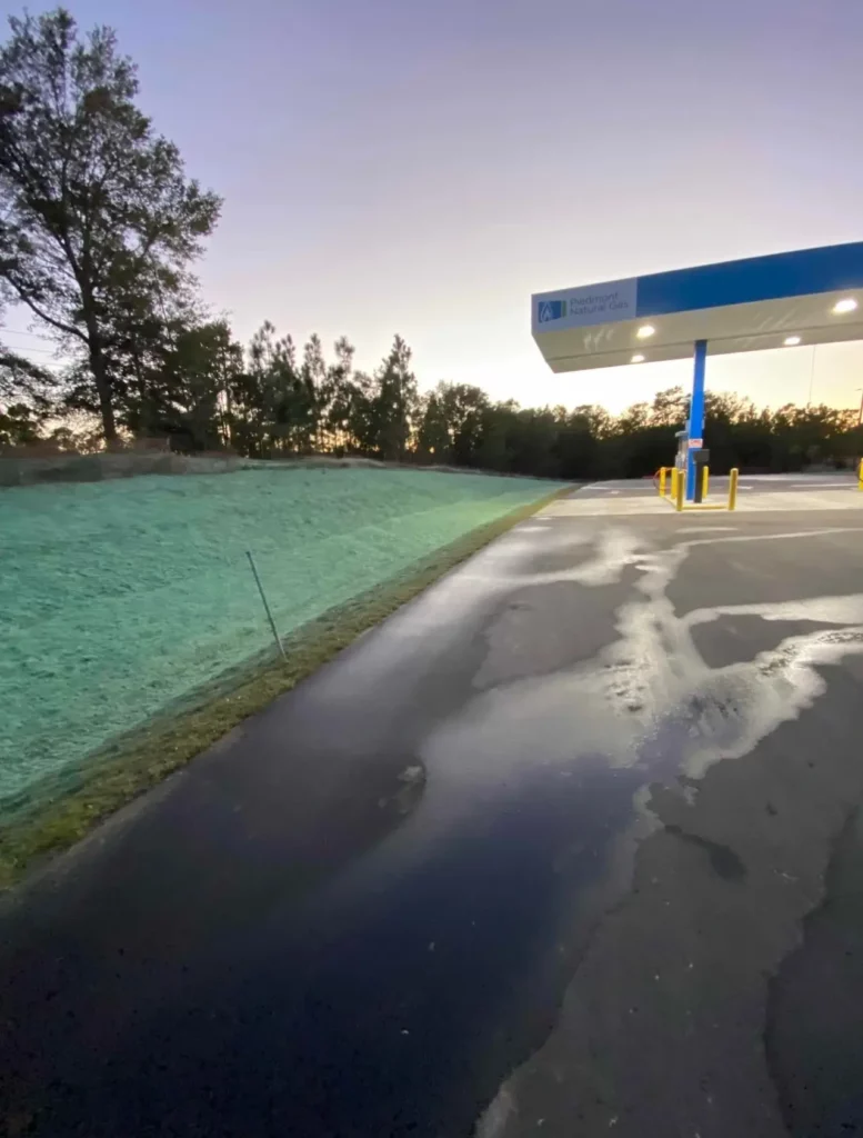 A gas station with a blue and yellow canopy