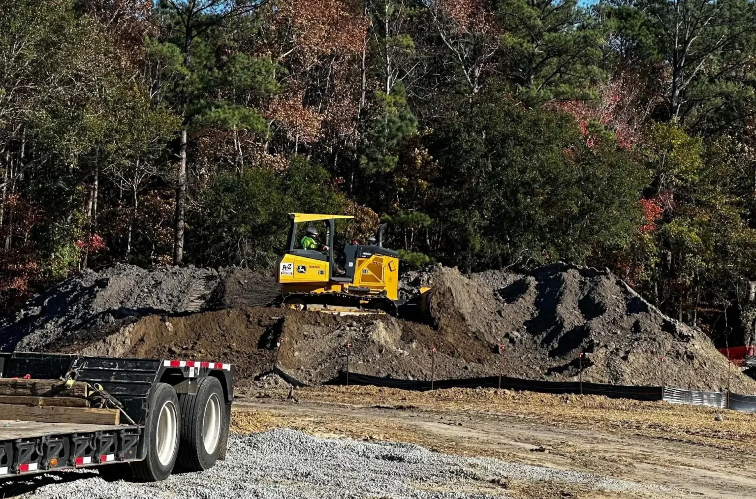 Grading a soil stockpile in preparation for stabilization with hydroseed application.