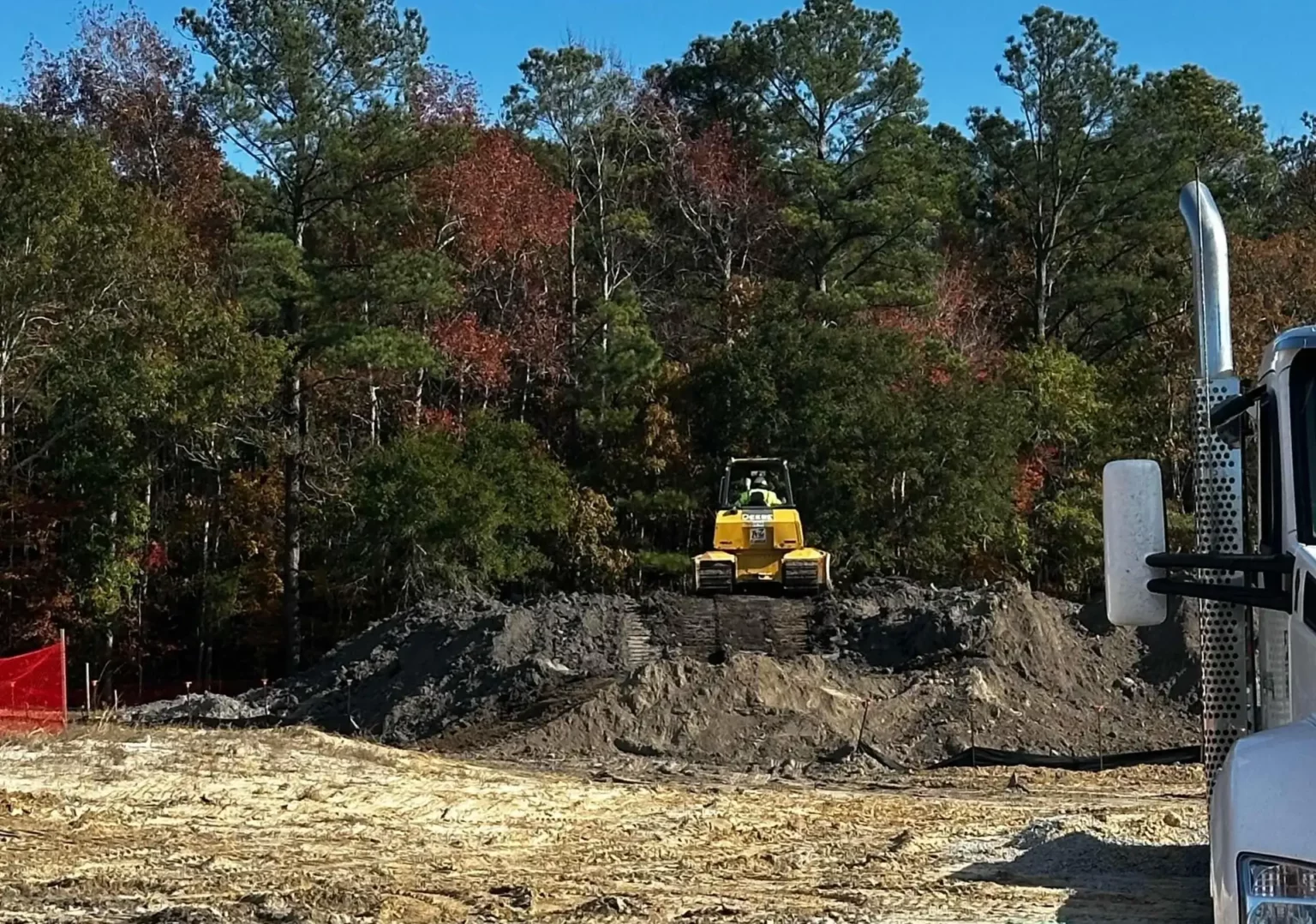 Grading a soil stockpile in preparation for stabilization with hydroseed application.