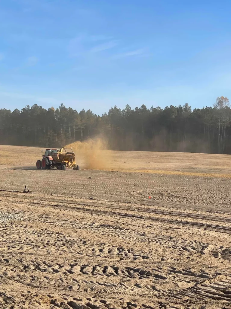 Haybuster blowing straw after seeding area