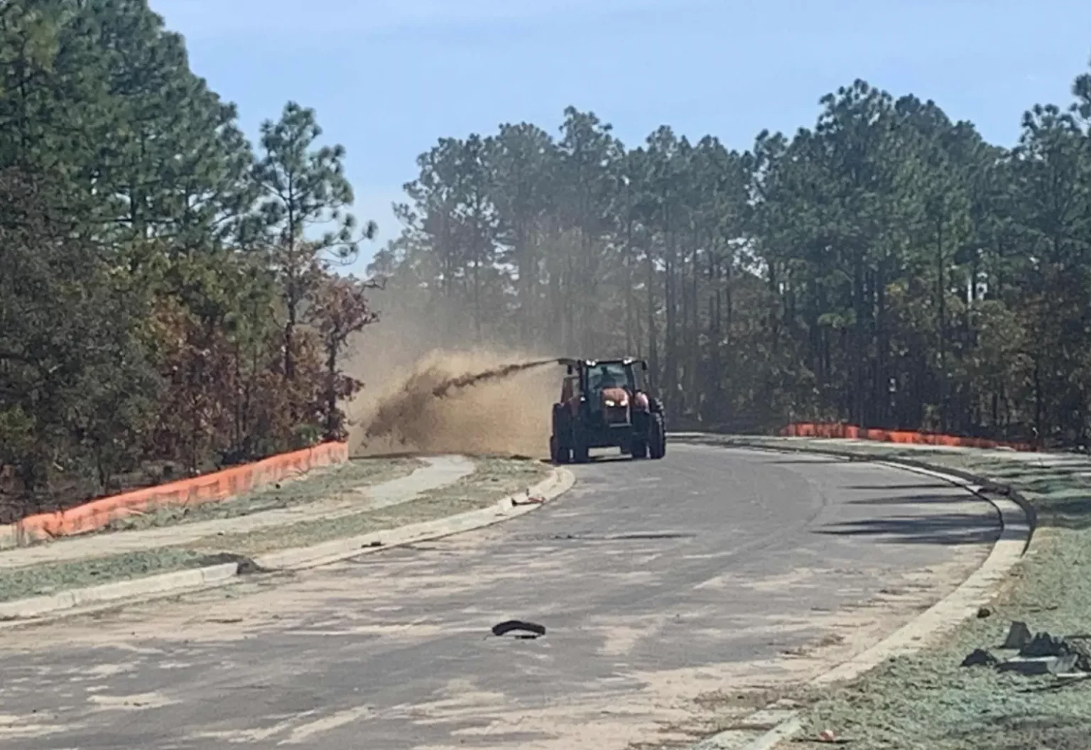Straw applied over a hydroseeded area to retain soil moisture, regulate temperature, and support optimal seed germination conditions.