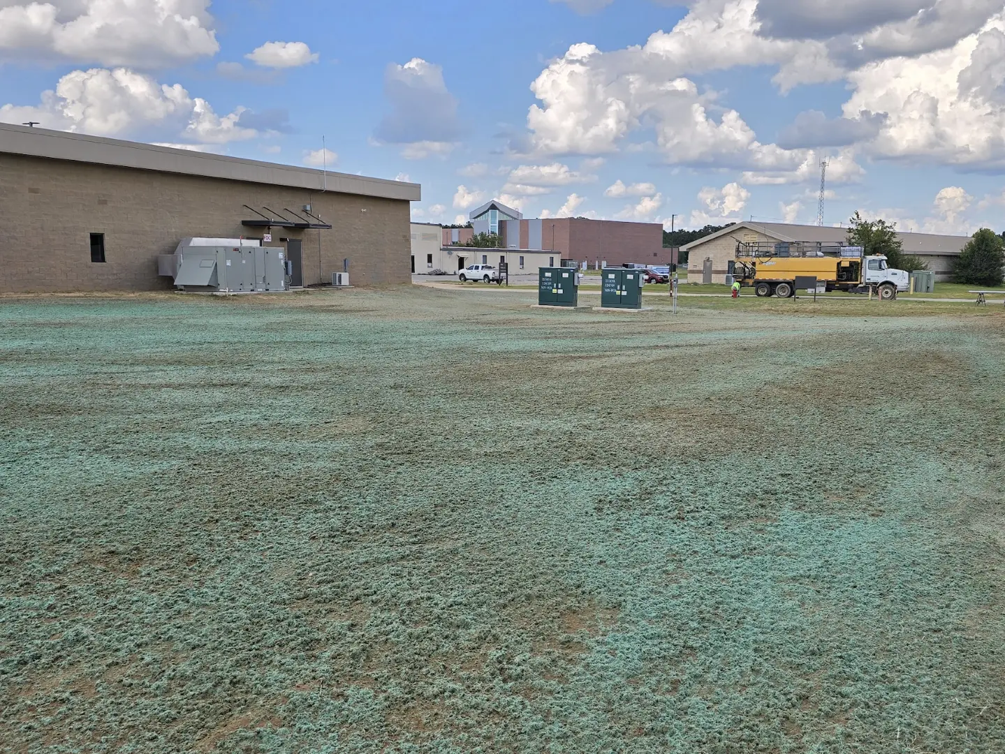 Completed hydroseeding around newly graded buildings at Shaw Air Force Base to stabilize soil and encourage turf establishment.